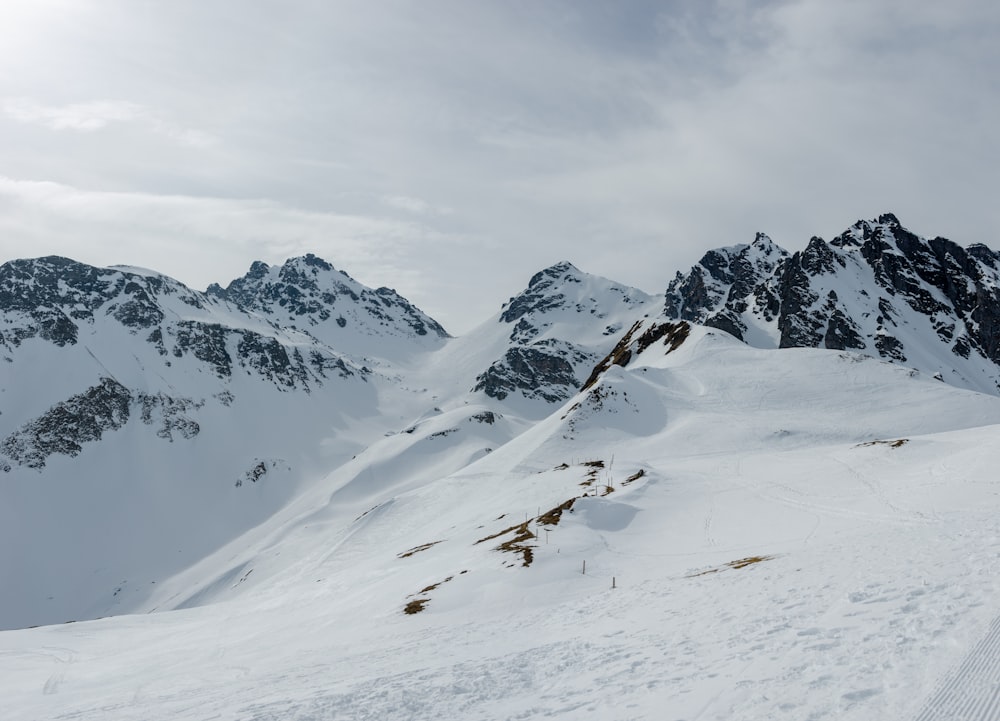 a man riding skis down the side of a snow covered slope