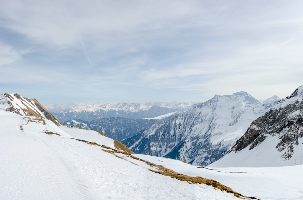 a man riding skis down the side of a snow covered slope