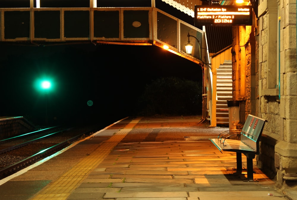 a bench sitting on the side of a train track
