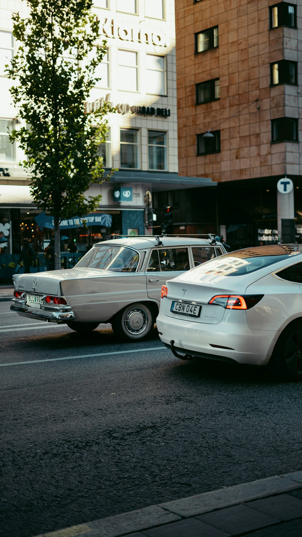 a couple of cars that are sitting in the street