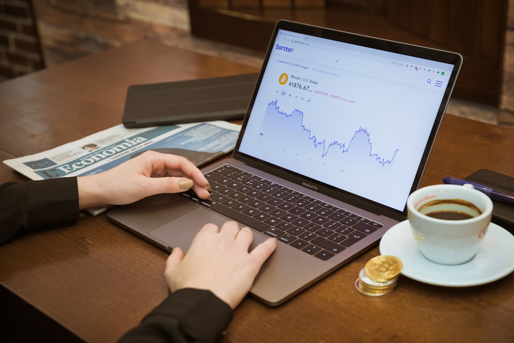 a person using a laptop computer on a table