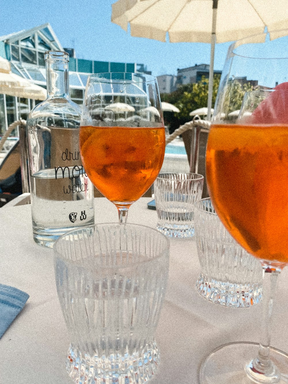 a table topped with glasses filled with liquid