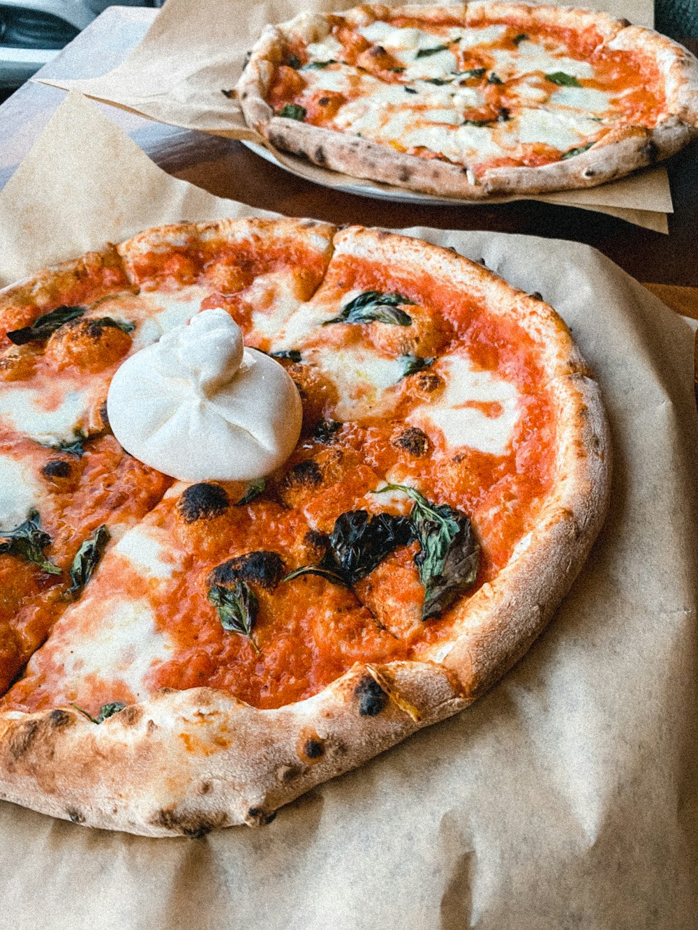 a couple of pizzas sitting on top of a table