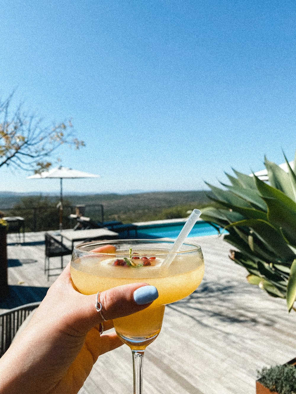 a person holding a drink in their hand