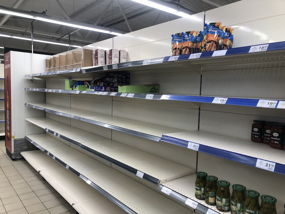 a row of empty shelves in a grocery store