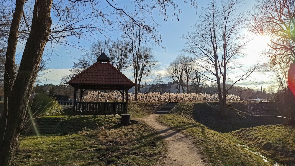 a gazebo in the middle of a grassy field