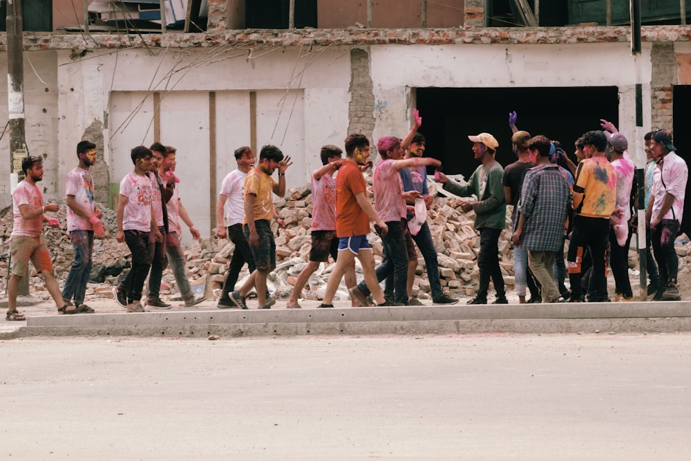 a group of people walking down a street next to a building