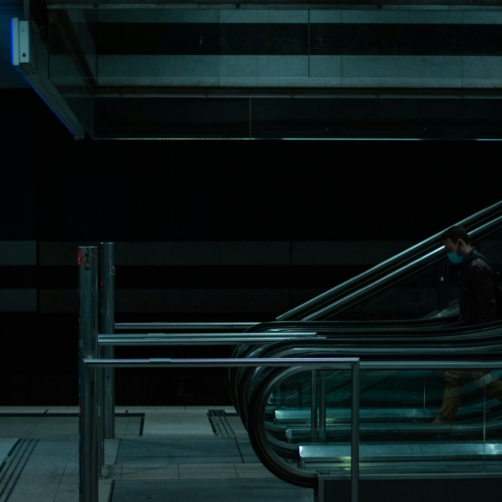 a man riding an escalator in a subway station