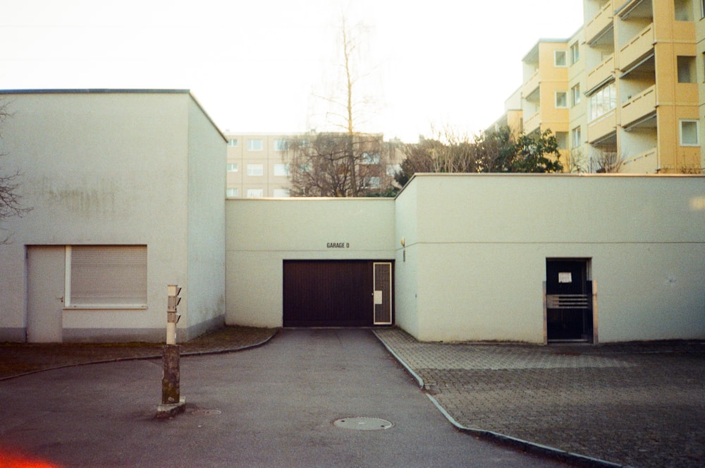 an empty parking lot with a building in the background