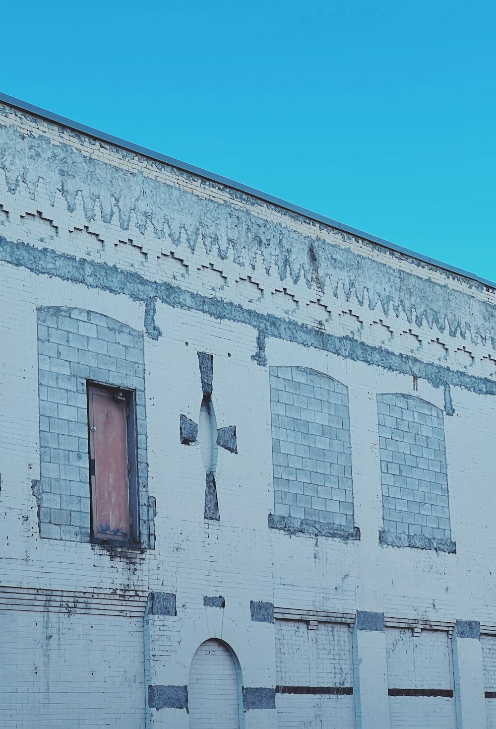 an old building with a cross painted on it