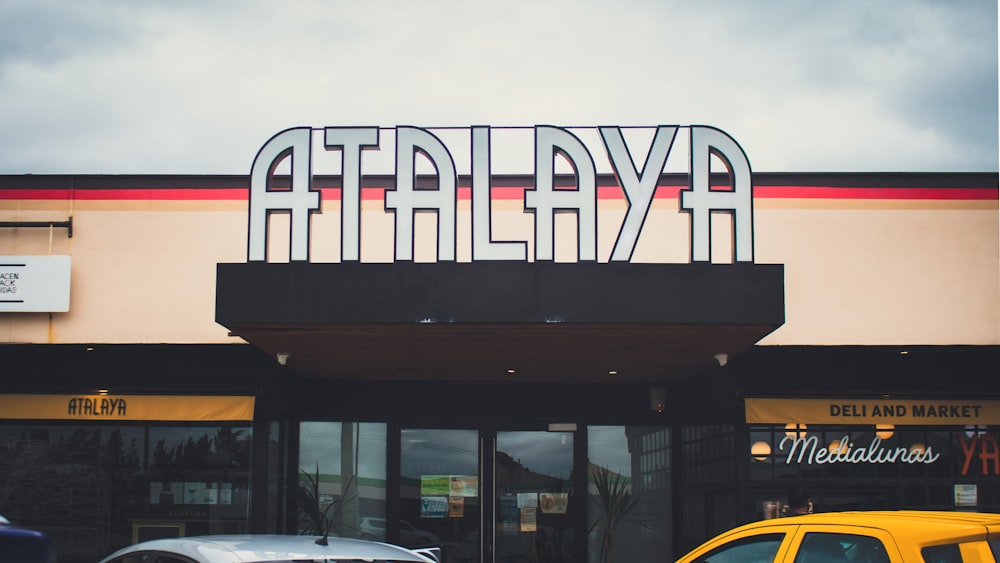 a yellow taxi is parked in front of a restaurant