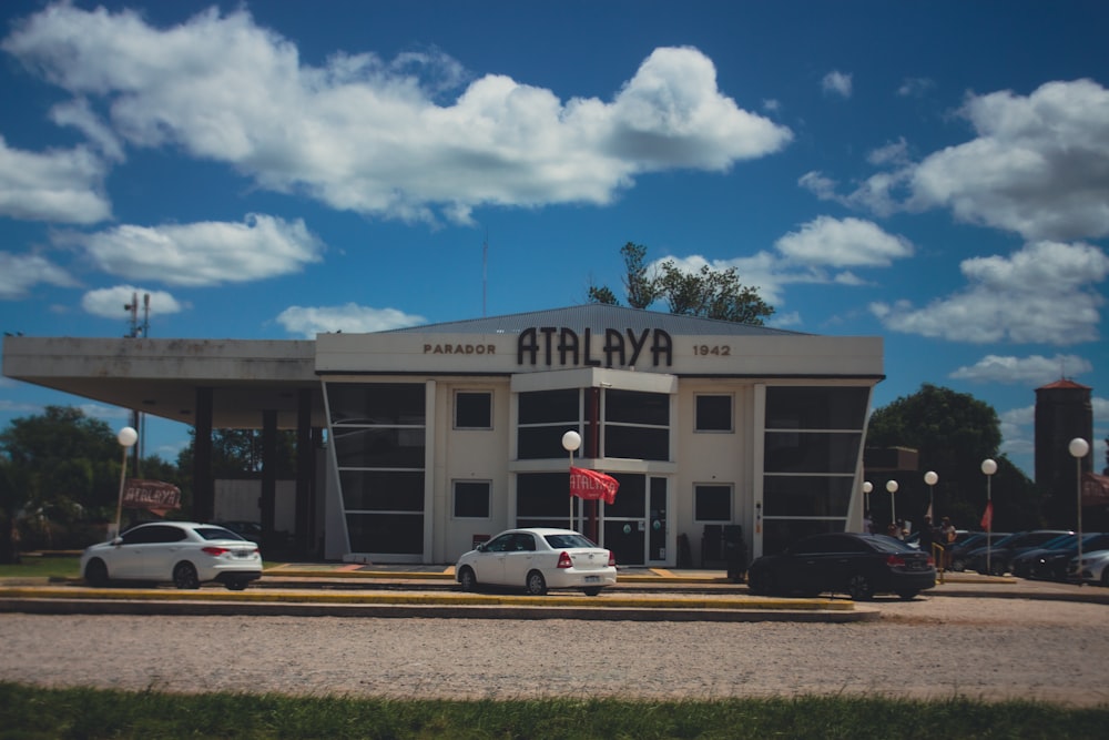 un edificio con coches aparcados delante de él