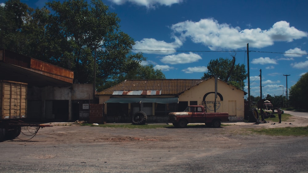 a red truck parked in front of a building