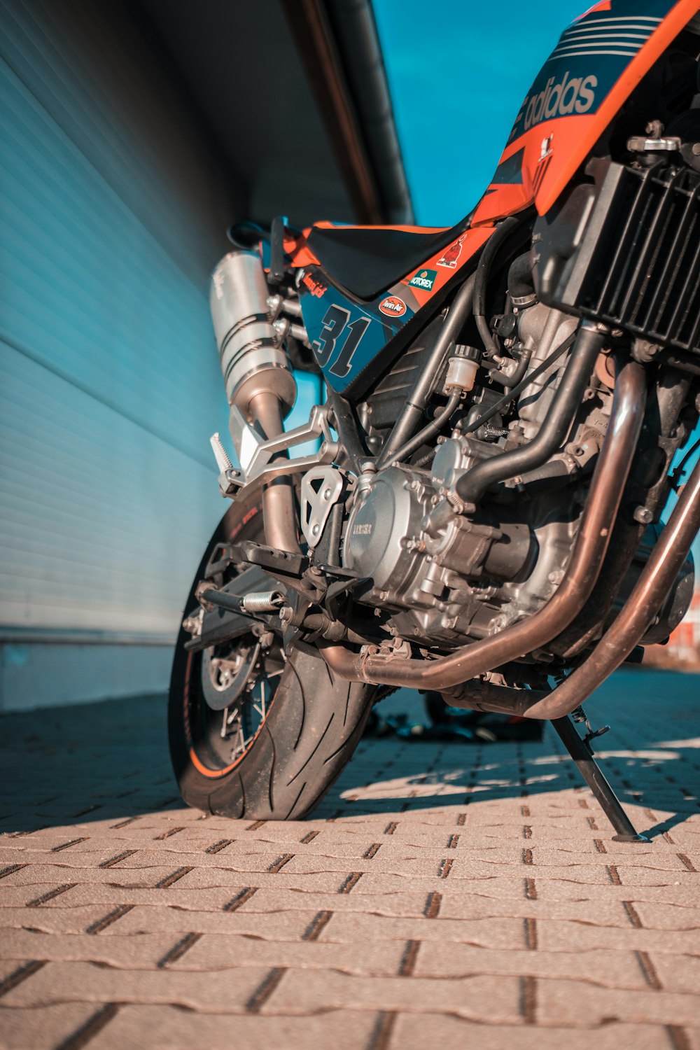 a close up of a motorcycle on a brick road