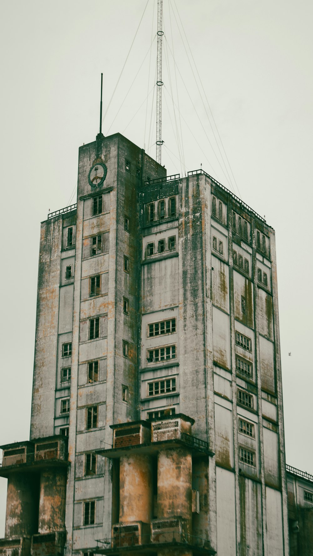 an old building with a clock on the top of it