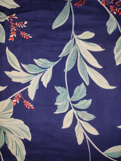 Artfully crafted keepsakes featuring bold orange hues and royal blue details, styled with palm leaves
