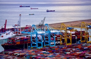 A bustling Saudi port showing containers being loaded, symbolizing international trade connections.