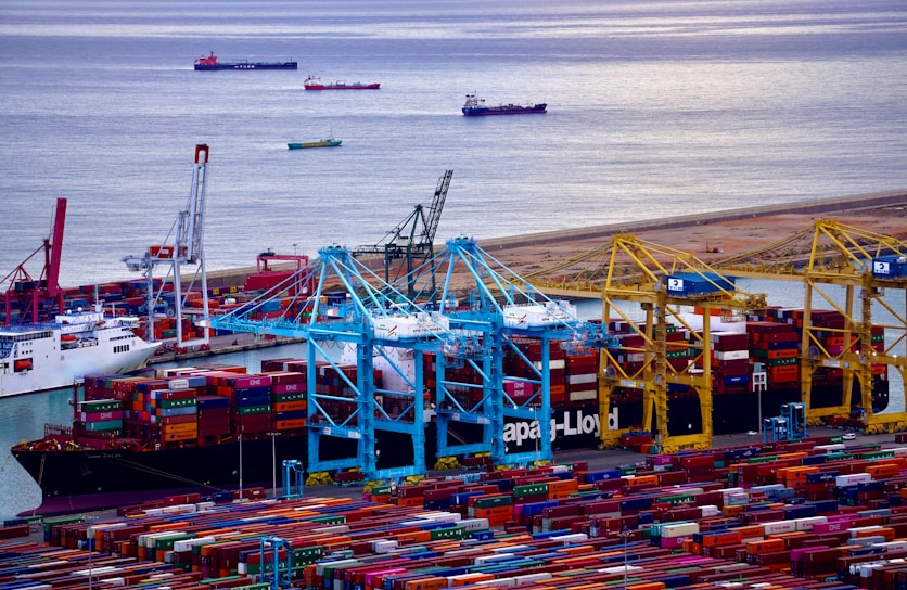 A vibrant image showcasing international shipping containers at a busy port.