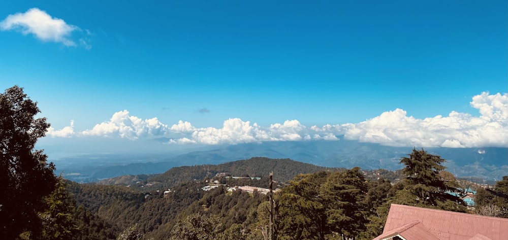 a view of a mountain range with a house in the foreground