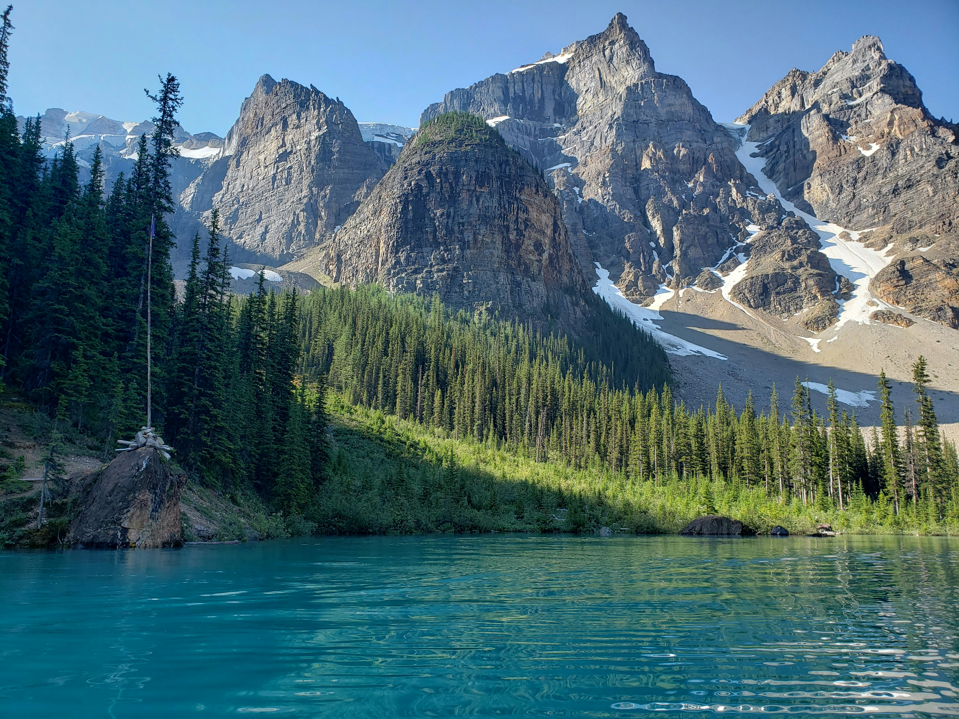 In the divine serenity of nature, near Moraine Lake, Banff, where the blue sky, rocky mountains, and turquoise vividness embrace each other.