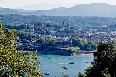 a view of a city and a lake with boats in the water