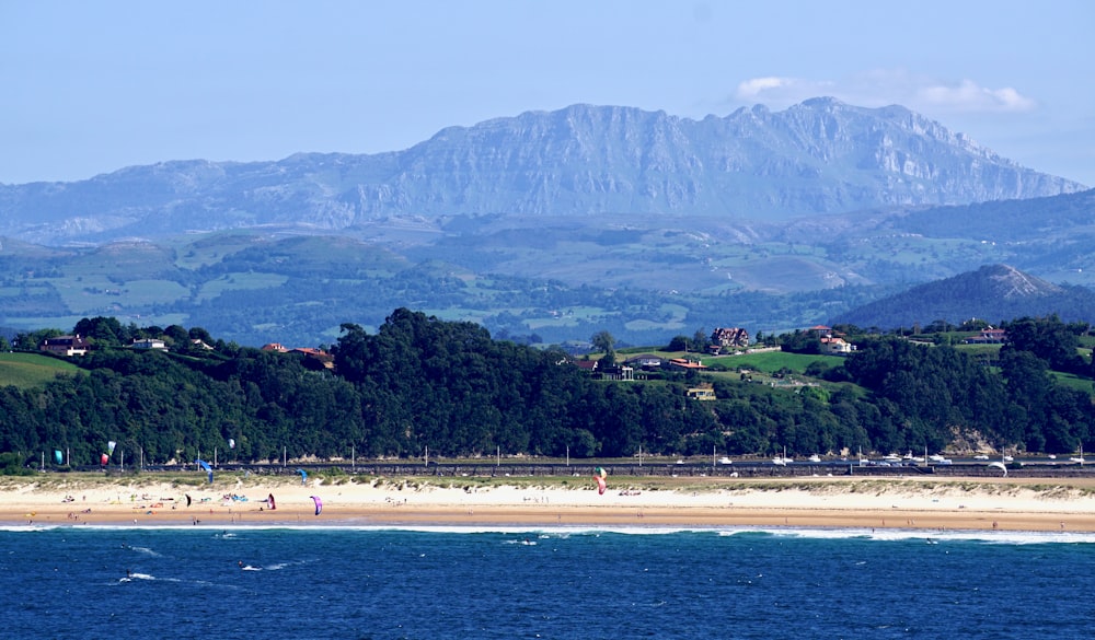 a view of a beach with mountains in the background