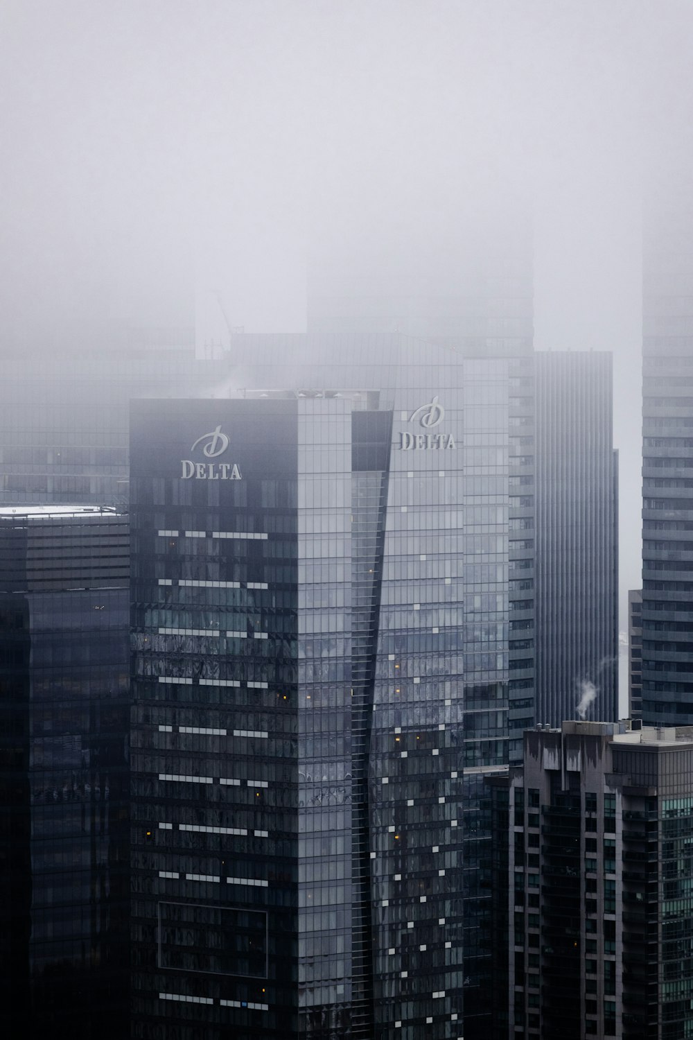 a foggy city skyline with tall buildings