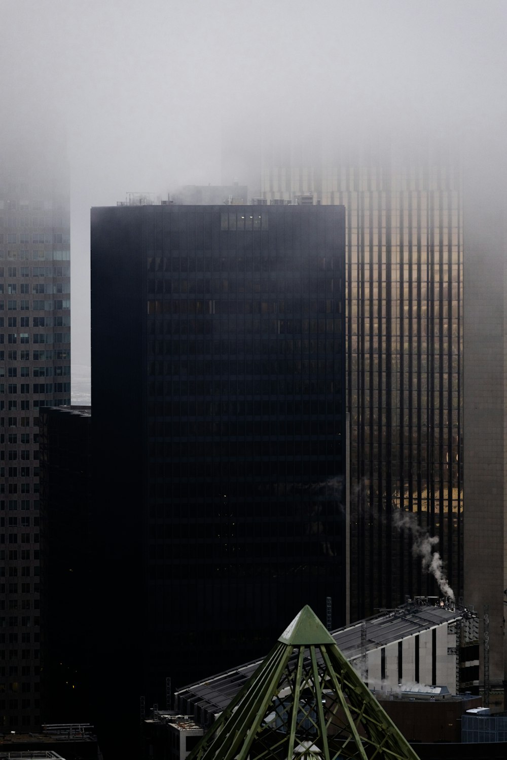 a view of a city with tall buildings in the fog