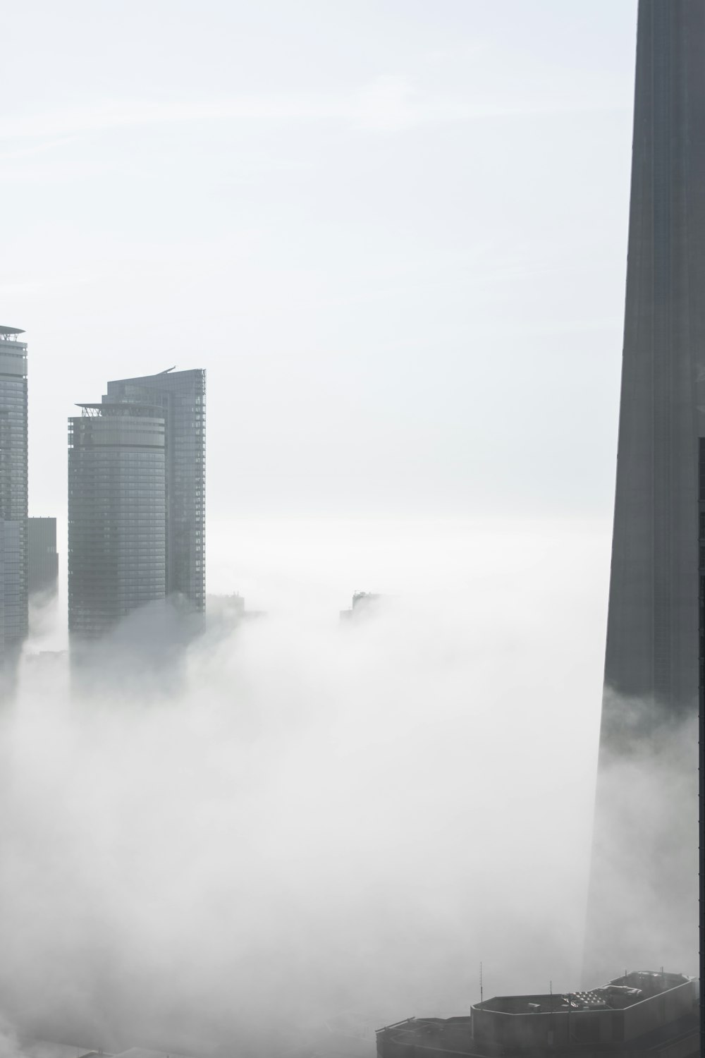 a very tall building with a lot of clouds in front of it