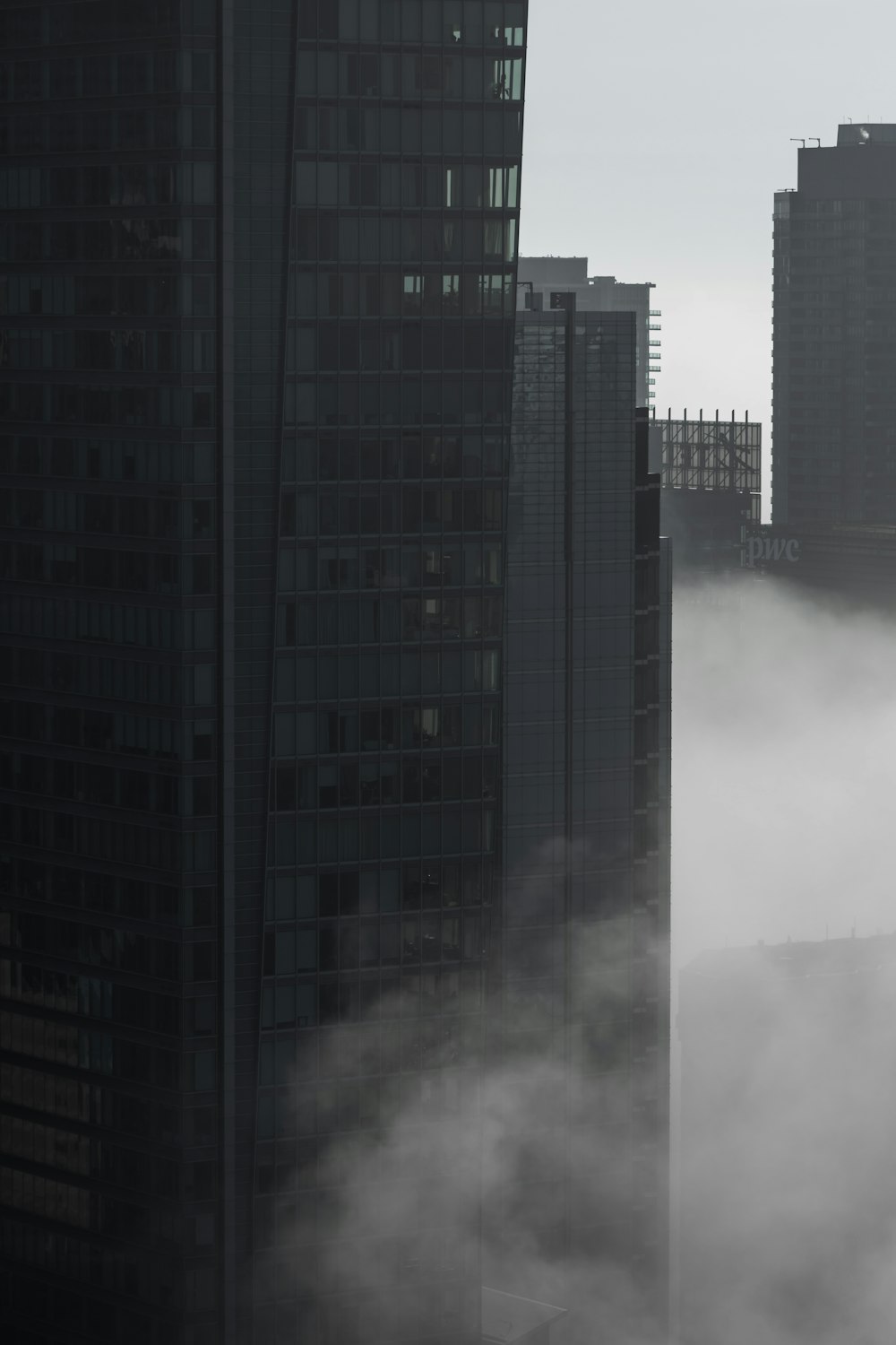 a city with tall buildings covered in fog