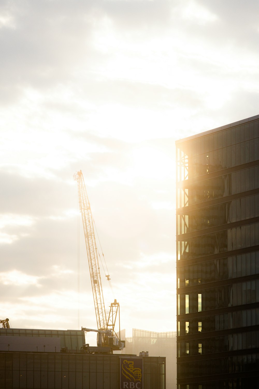 a building with a crane in the background