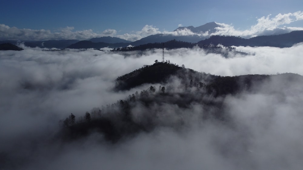 a view of a mountain covered in clouds