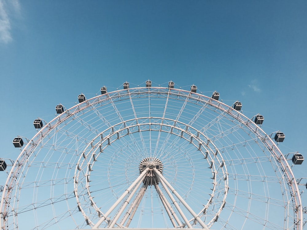 a large ferris wheel sitting under a blue sky
