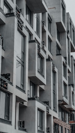 Contemporary urban building featuring geometric shapes and a neutral color palette.