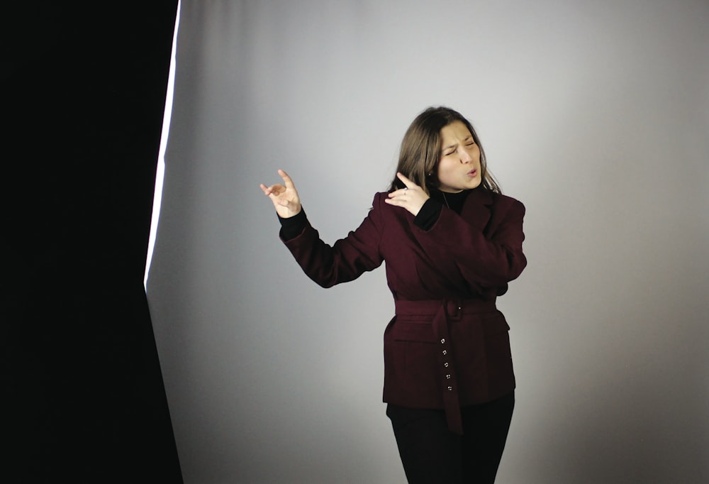 a woman standing in front of a gray background