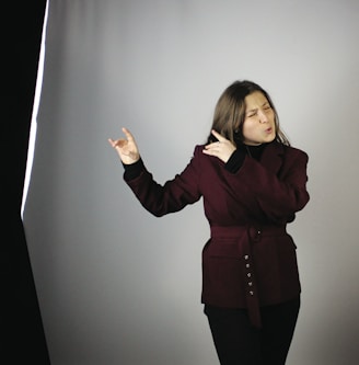 a woman standing in front of a gray background