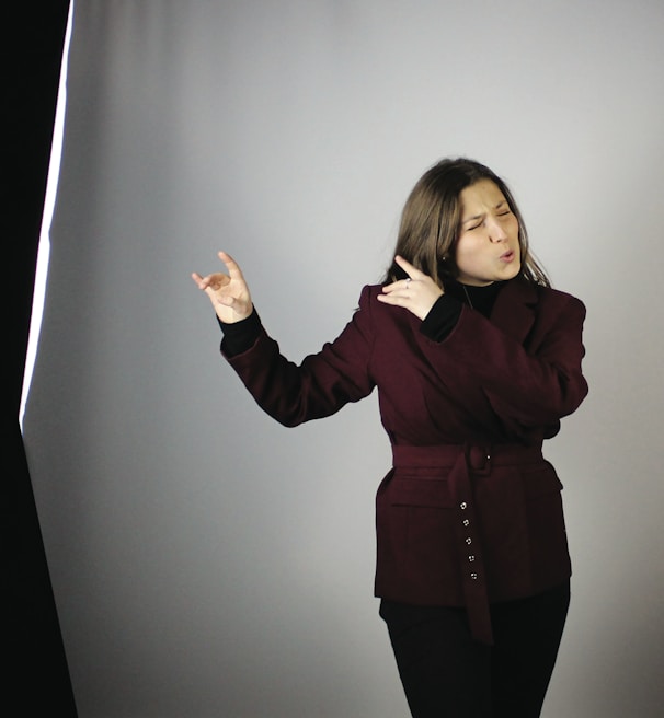 a woman standing in front of a gray background