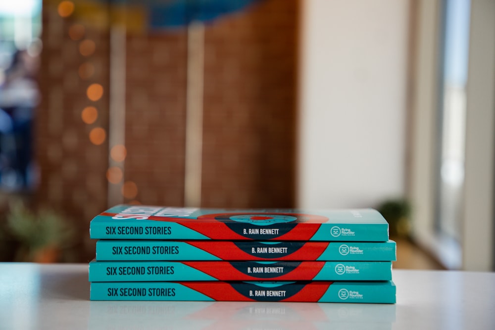 a stack of three books sitting on top of a table