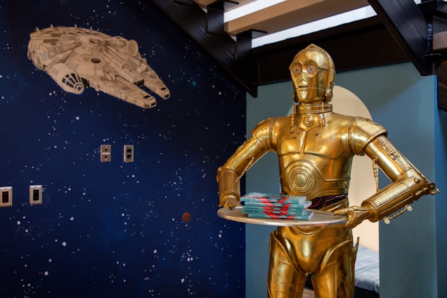 a man in a star wars costume holding a cake