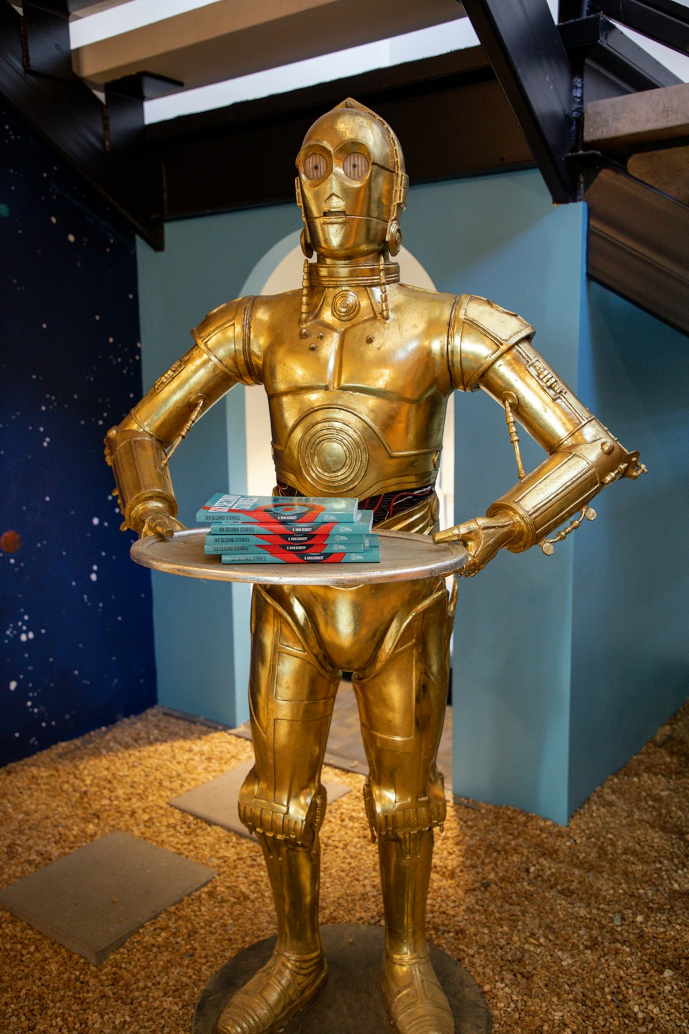 a star wars character holding a cake on a plate