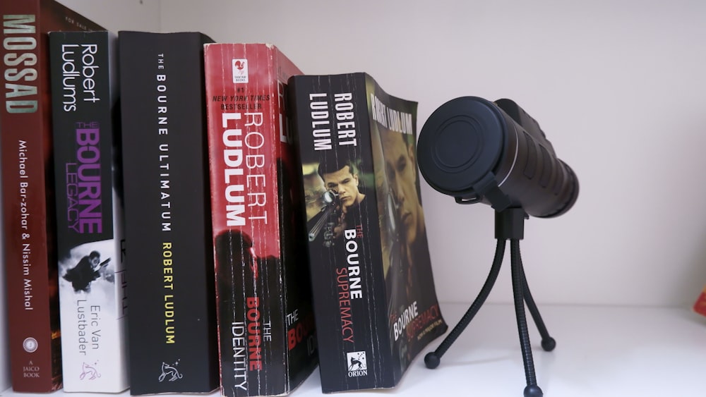 a camera sitting on top of a book shelf