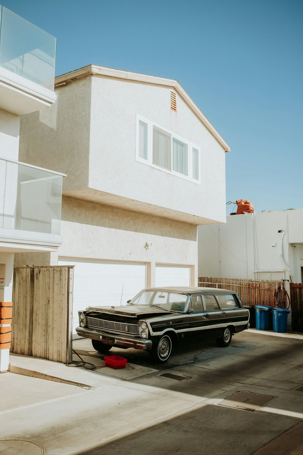 a black station wagon parked in front of a house