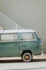 A pristine 1960s Volkswagen Transporter T1 parked in a sunlit vintage garage.