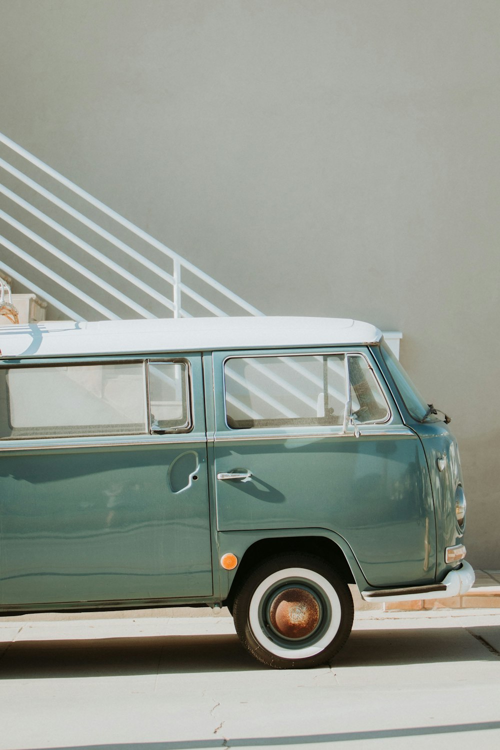 a green and white van parked in front of a building