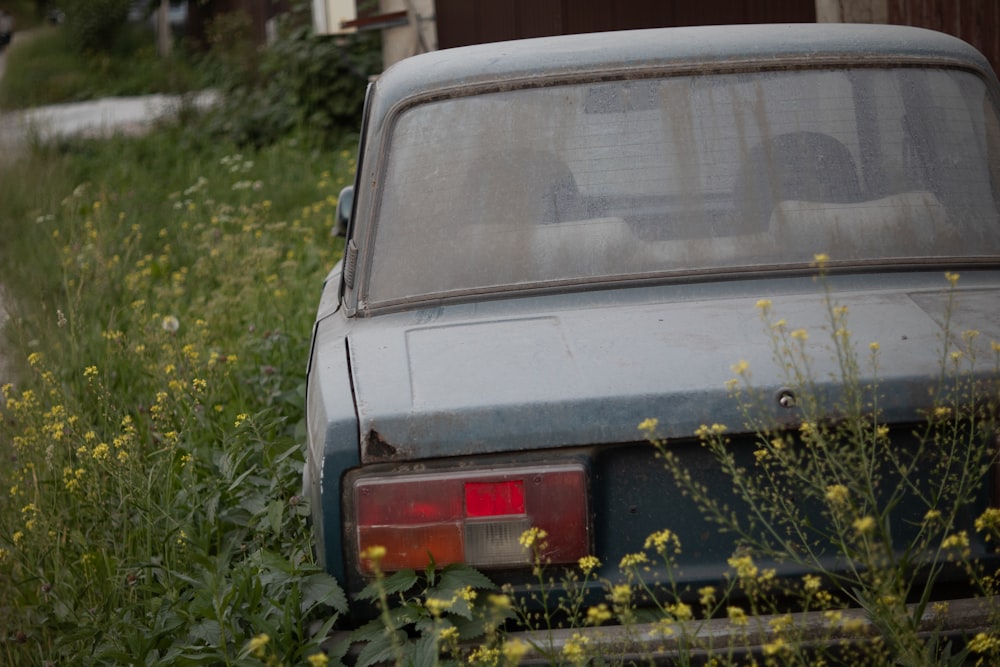 a car parked in a field of tall grass