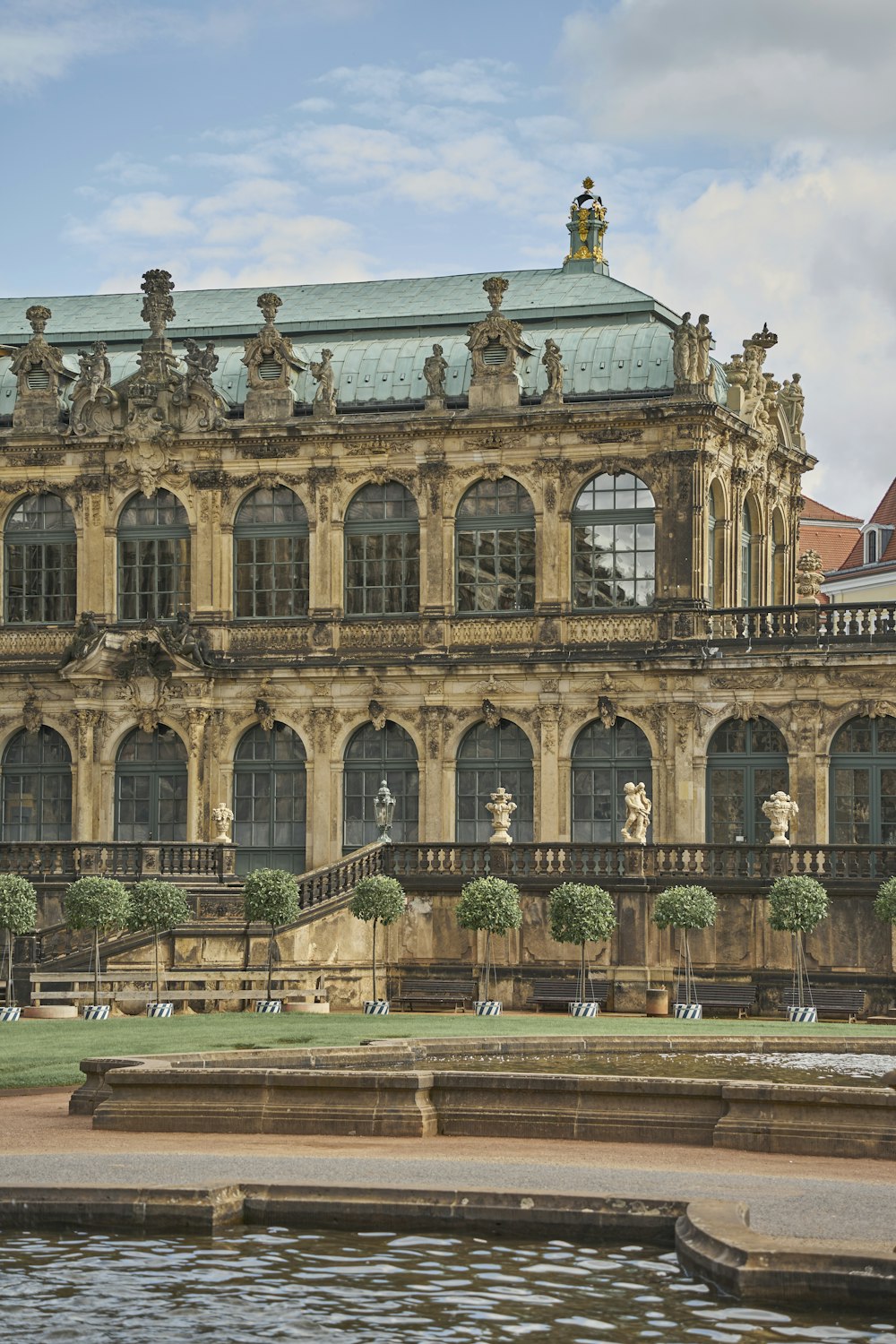 a large building with a fountain in front of it