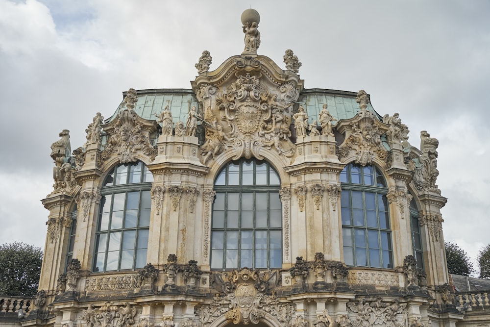 a large building with many windows and statues on it