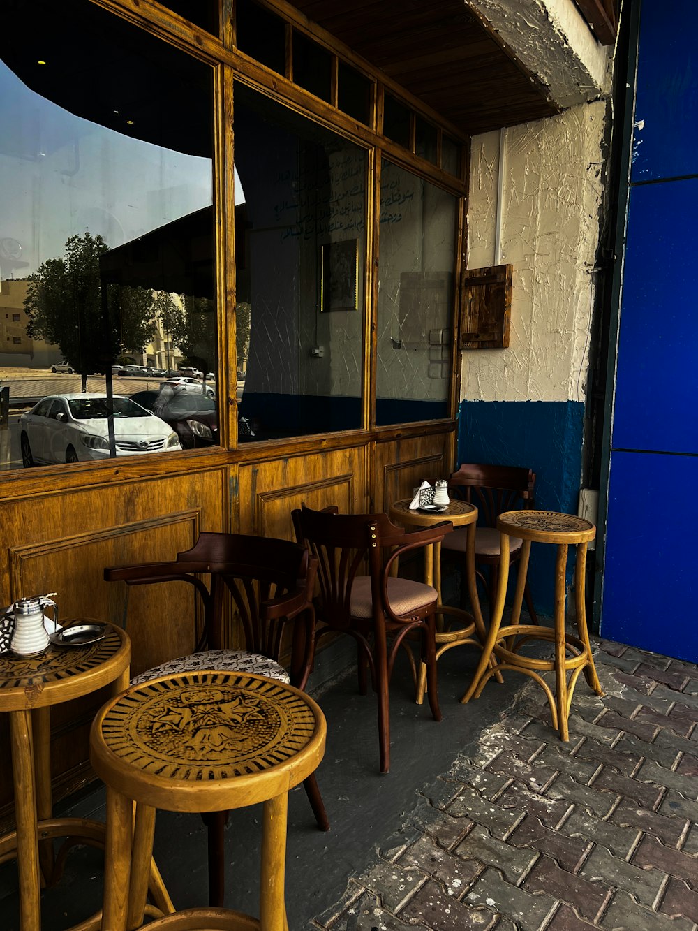 a row of wooden tables sitting next to a building