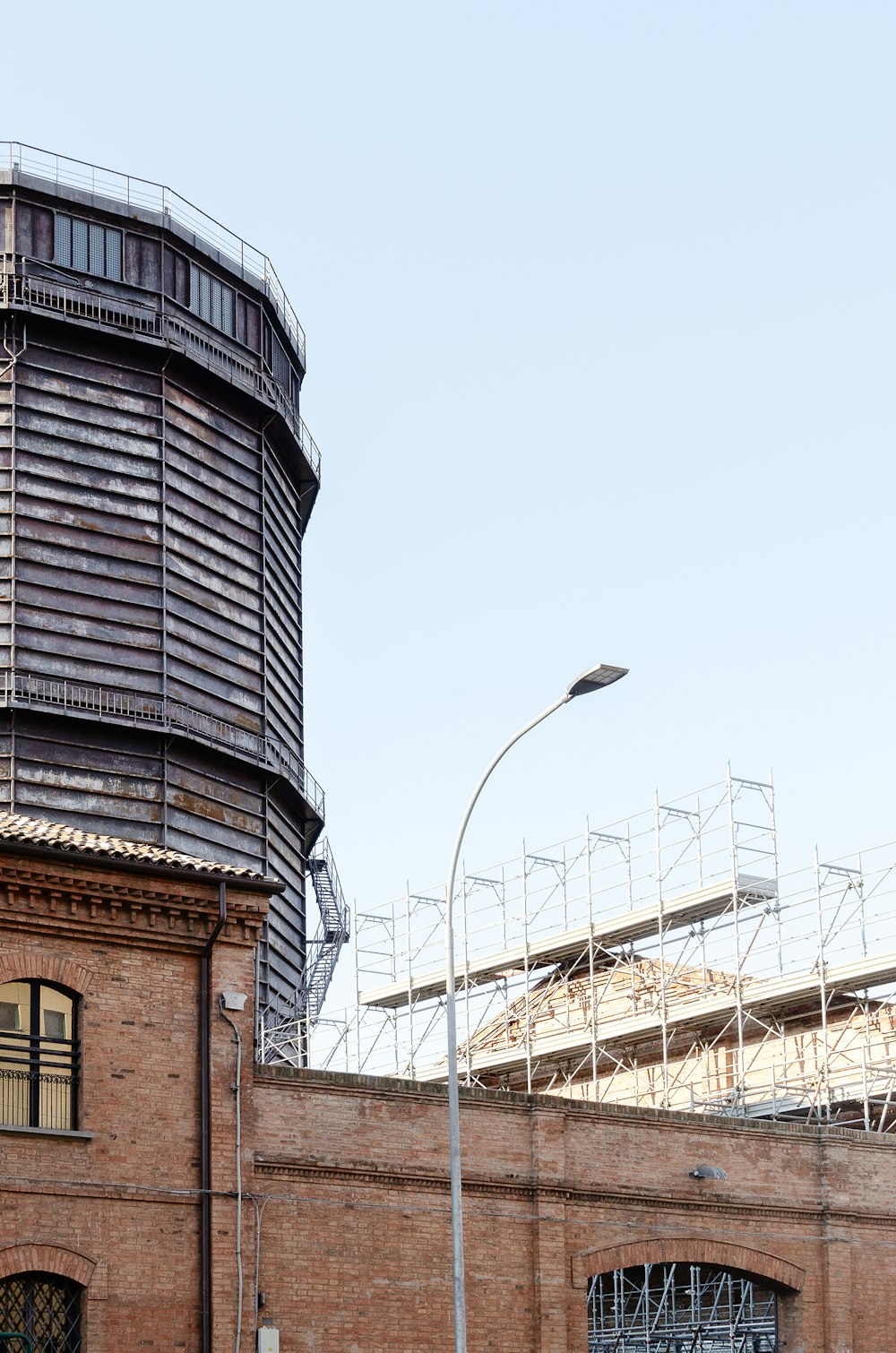 a tall brick building with a clock tower next to it