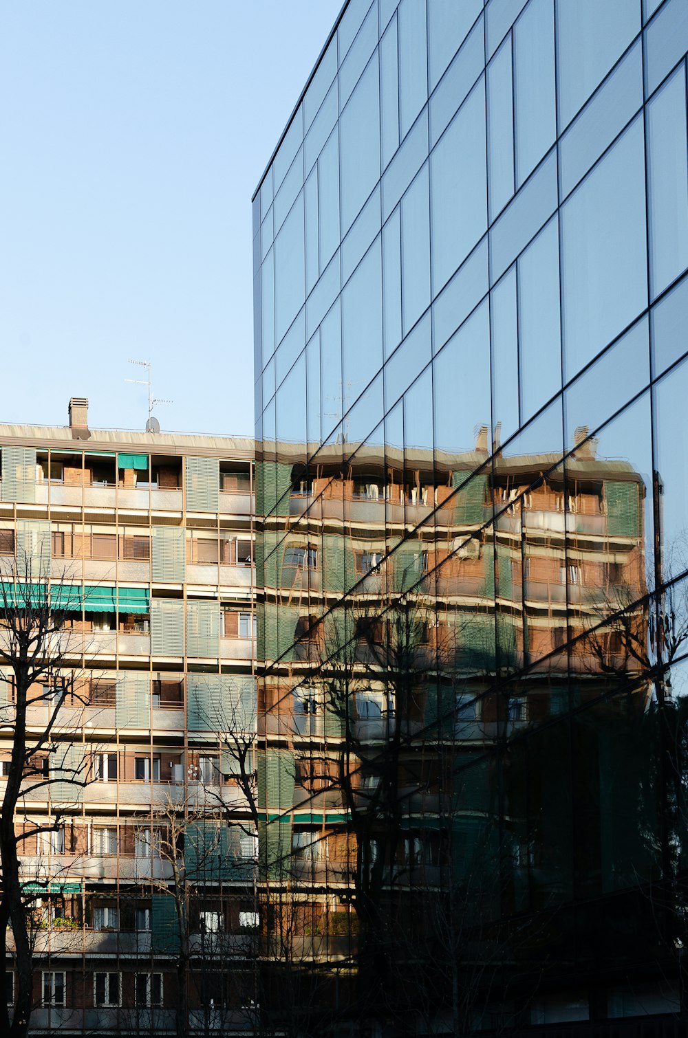 a large building with a lot of windows next to trees